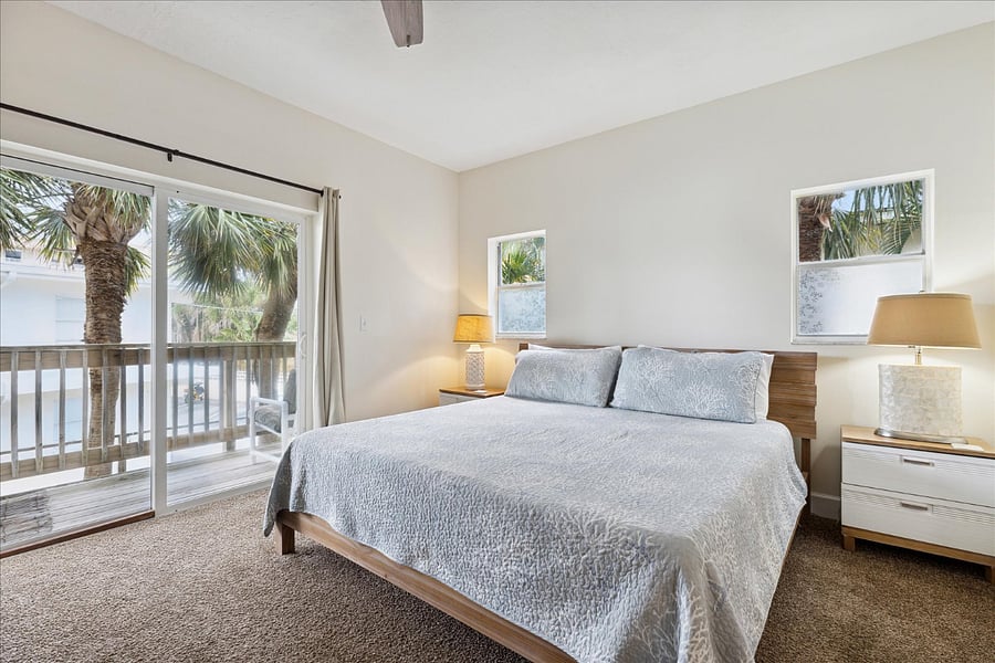 Cozy master bedroom w/ king size bed, soft linens, natural light and a private balcony retreat.