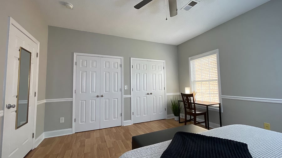 Bright and inspiring! Our room features crisp light painted walls, a stylish desk, and a table perfect for work or play