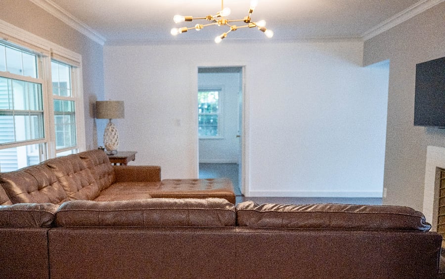First living room with TV and cozy large sectional for relaxation and unwinding.