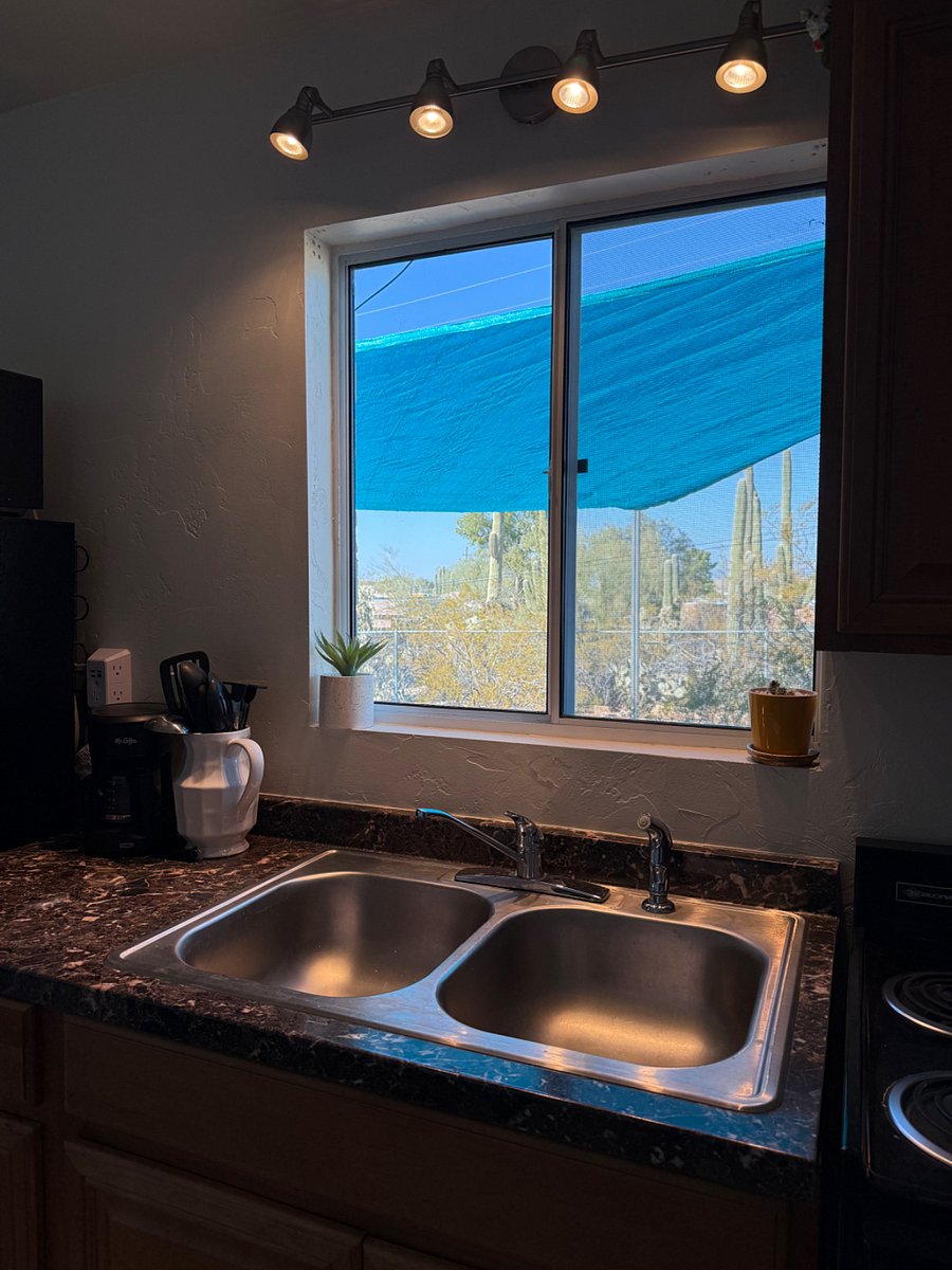 A huge picture window frames the desert patio. 