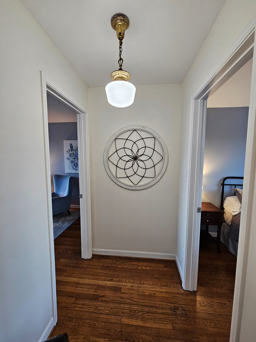 Upstairs landing. Primary bedroom on left and guest to the right