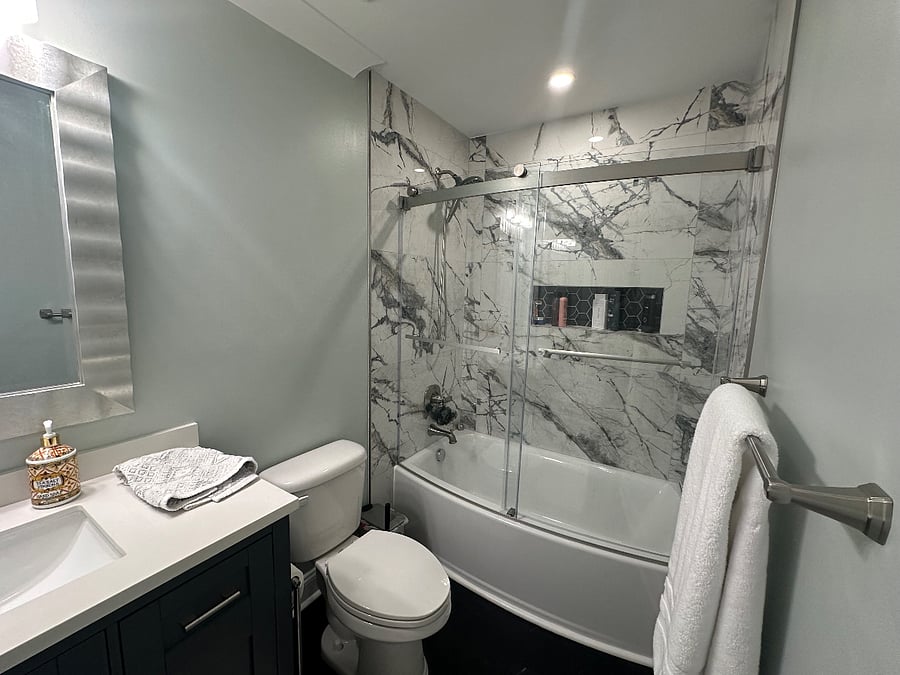 Primary Bathroom features custom tile and oversized vanity.