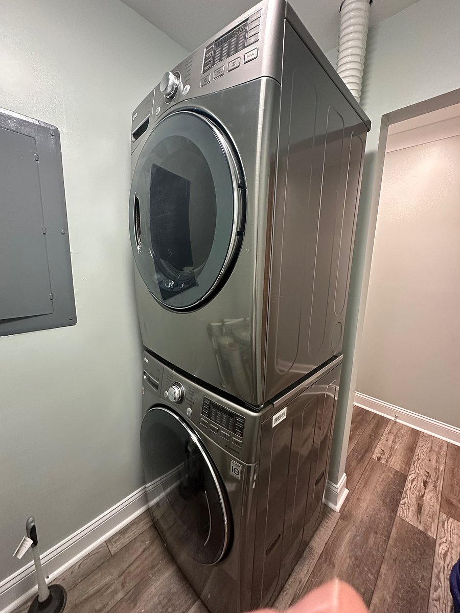 Laundry with stacked front load washer and dryer 
