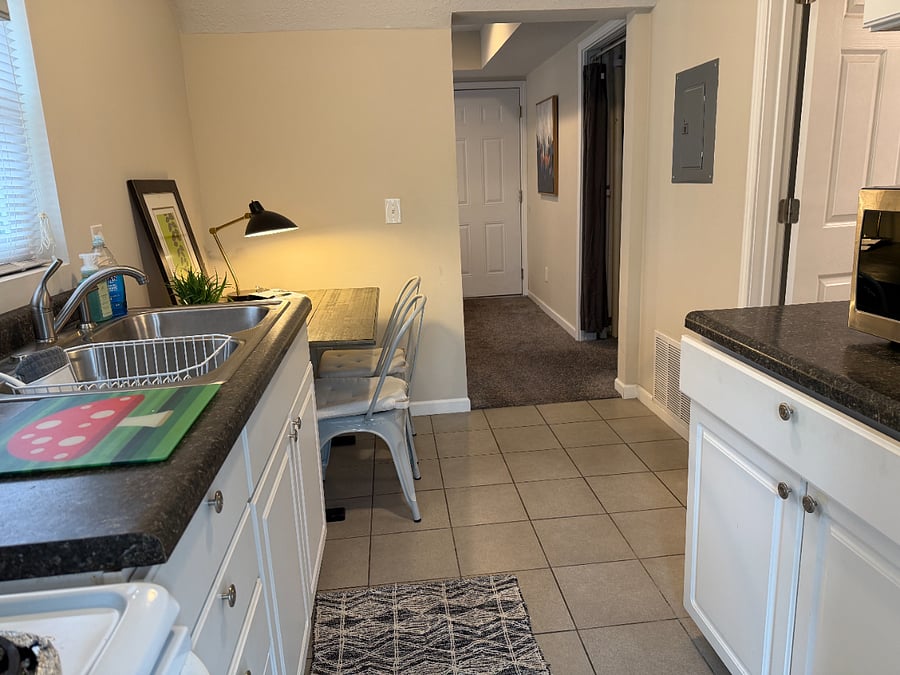view from kitchen towards living space, bathroom on right