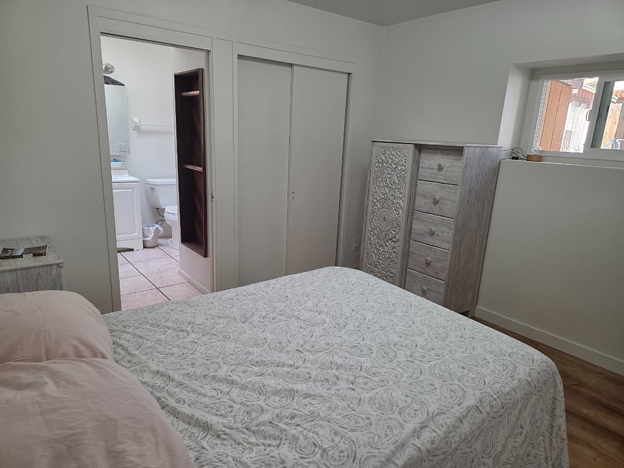 Bedroom three downstairs has full bath, closet dresser and night stands, full size bed