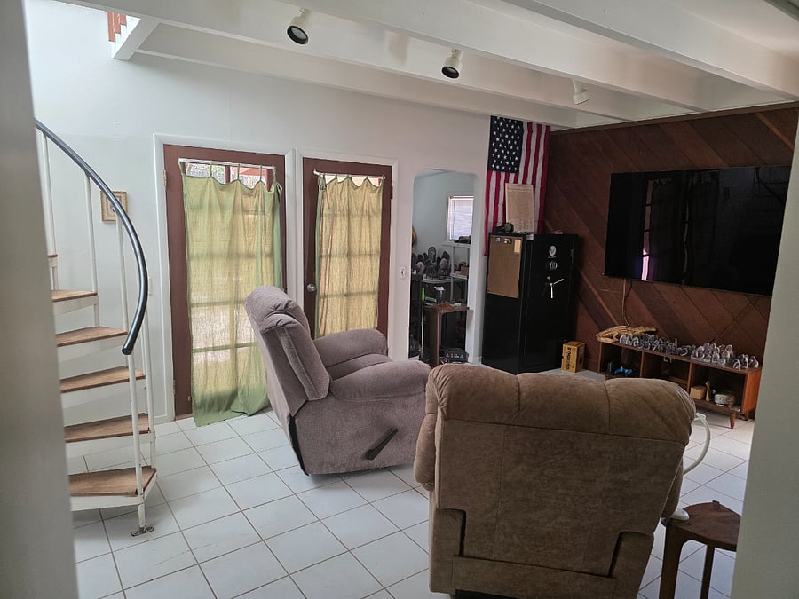 Den has LaZboy style recliners, bonus room, garden entrance, endtrance to Bedroom 2 queen suite, Bedroom 3 full suite and spiral stairs to Bedroom 1