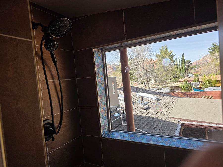 walkin ahower has 2 shower heads and views of thunder mountain in the winter time (from April - November the view is obscured by the beautiful trees). This window is private only those in the homes backyard can see into the window, it also has an exterior blind with remote for privacy.