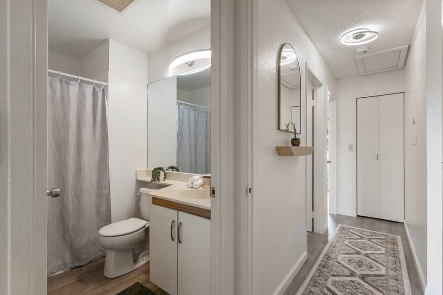 Step into a spotless bathroom with modern finishes and cozy accents. Whether its a quick refresh or a long soak, this space is made for comfort.