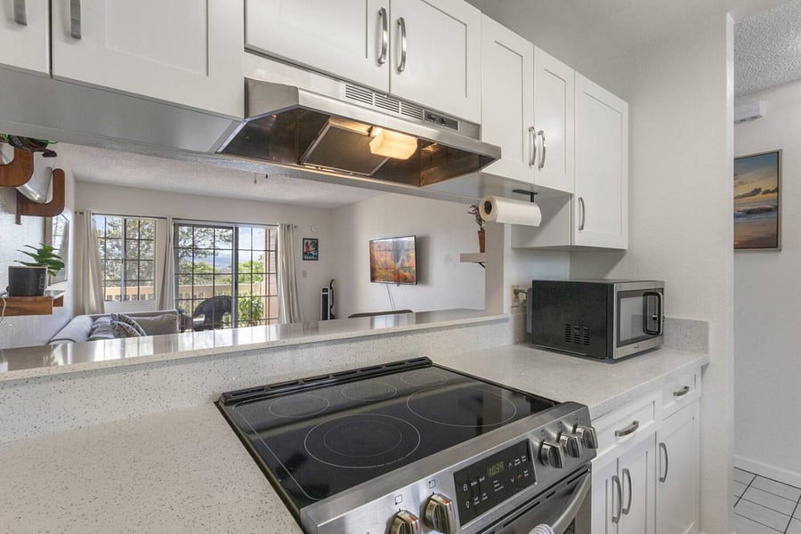 This open-concept kitchen lets you stay part of the action while prepping meals. With a view into the living room and natural light pouring in, its designed for effortless living.
