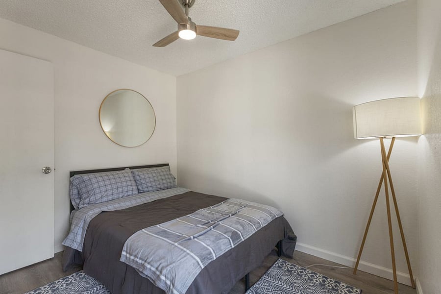 Clean lines, cool tones, and a touch of personality make this bedroom a peaceful retreat for travelers who appreciate thoughtful design.