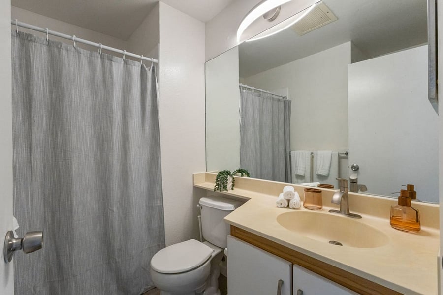 From the spacious mirror to the modern faucet and thoughtful touches, this space makes freshening up feel effortless.