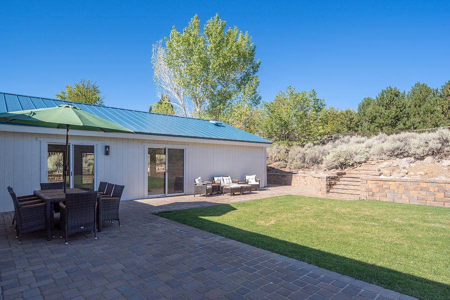 Private backyard with wrap around paver patio for entertaining and relaxation. Grass is professionally maintained.