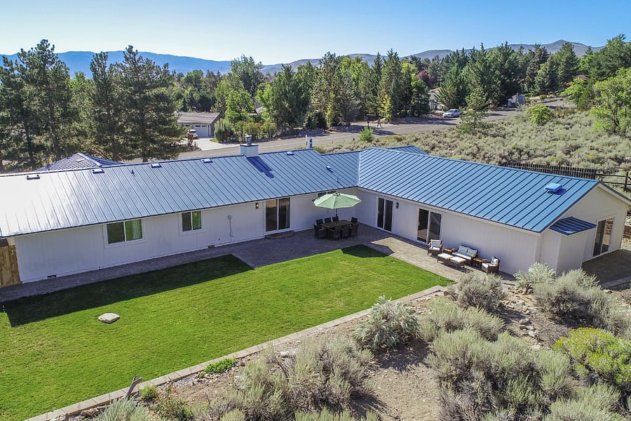 Private backyard with wrap around paver patio for entertaining and relaxation. Grass is professionally maintained.