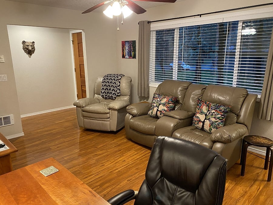 Family room with smart TV , cable and gaming console, Desk/Work area, bookshelf with books.