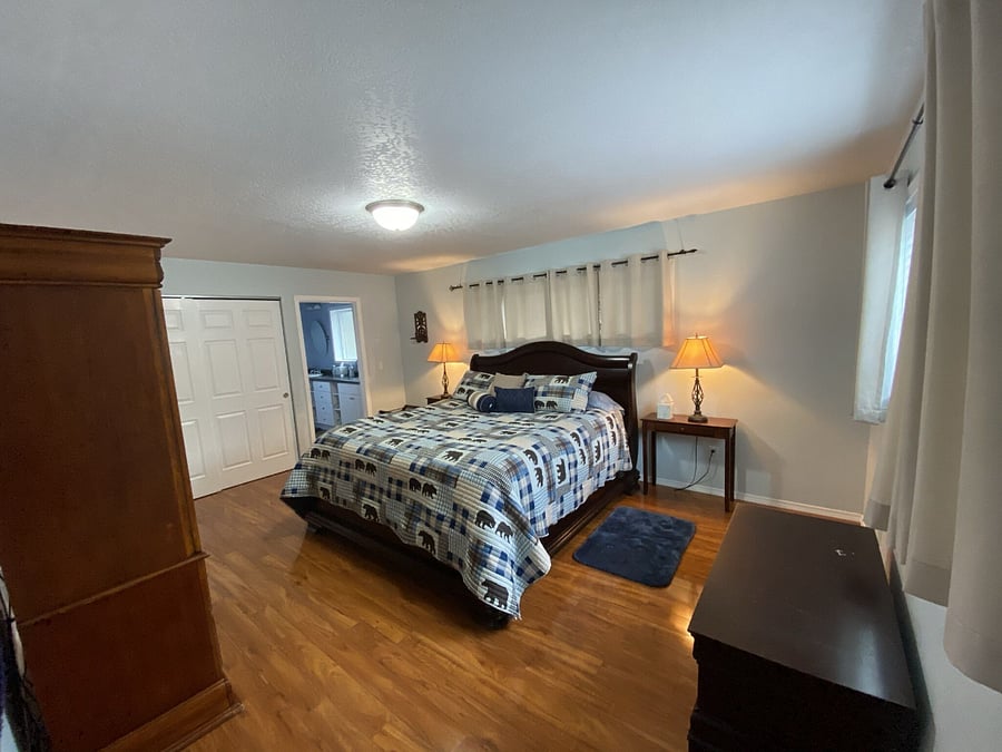 Master Bedroom with kind bed, two closets, 2 twin cots, Smart TV with cable, and private master bathroom.