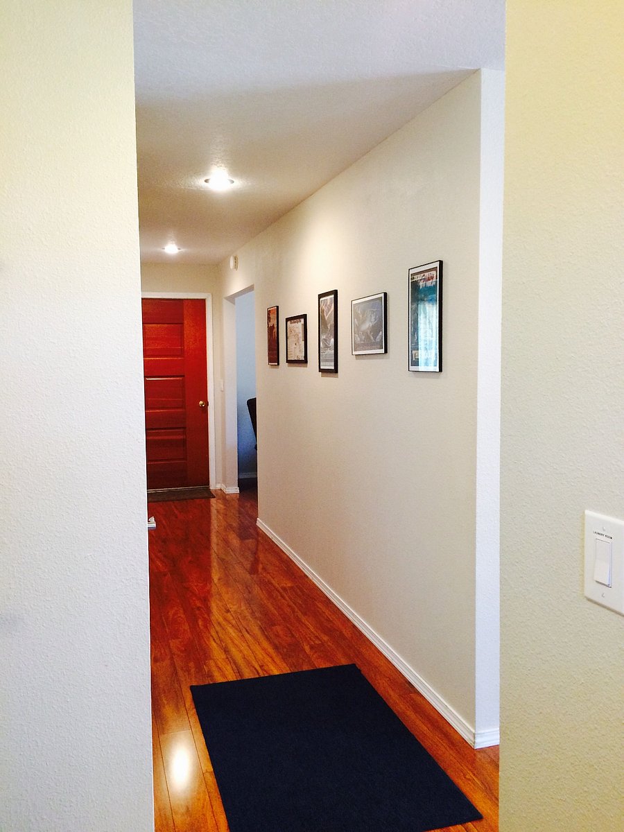 Hallway between living room/dining room and kitchen headed to family room. Door goes out to the newly added fenced in yard for kids and pets.