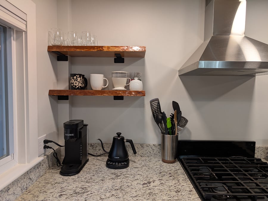 The kitchen comes stocked with pots, pans, a variety of coffee making items, silverware, plates, glasses, and more. 