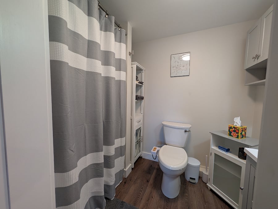Bathroom includes shower, sink, and toilet with bidet attachment