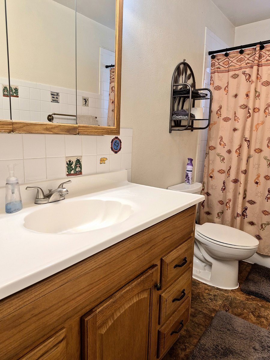 Bathroom is complete with towels, soaps, and cleaning products.