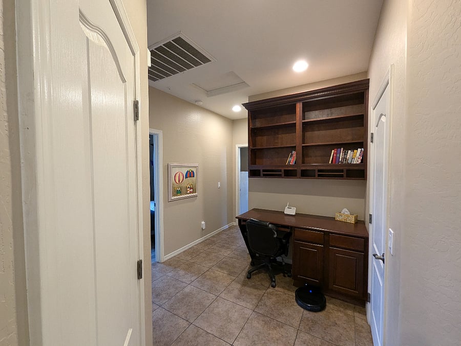 built in desk and bookcase in hallway with 2 closet spaces