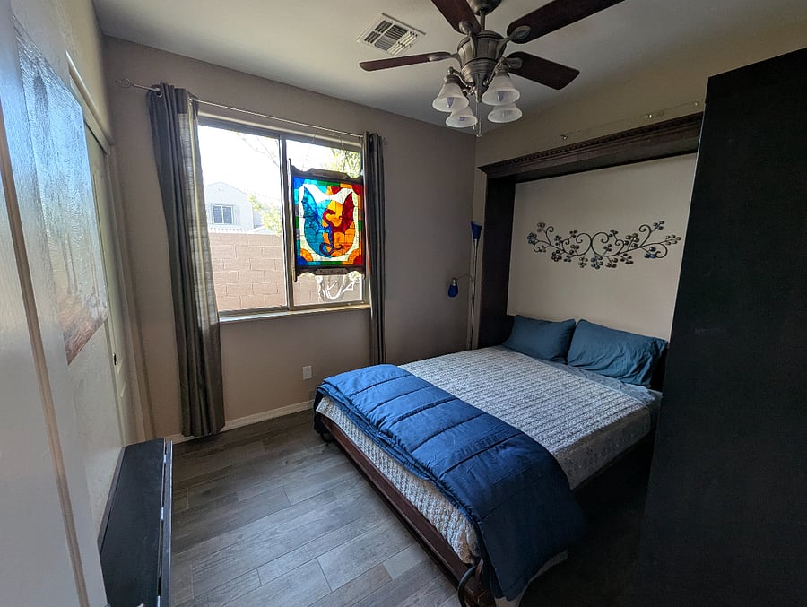 Bedroom with a queen size murphy bed, folds into wall cabinet for open floor space