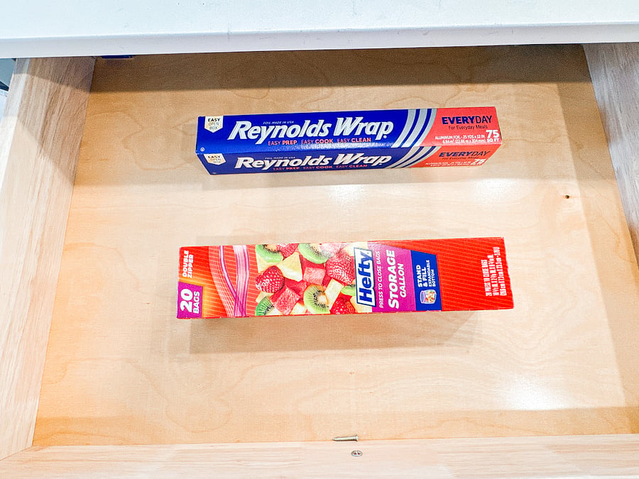 Convenient kitchen essentialsReynolds wrap and plastic bags for easy storage
