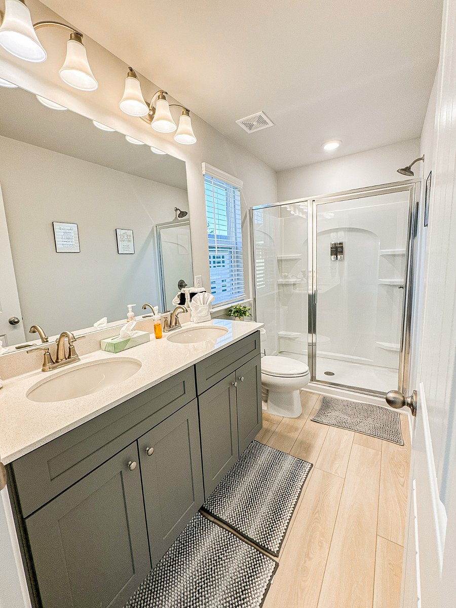The luxurious primary bathroom, attached to Bedroom 1, features a spacious walk-in shower and a double vanity sink for added convenience.
