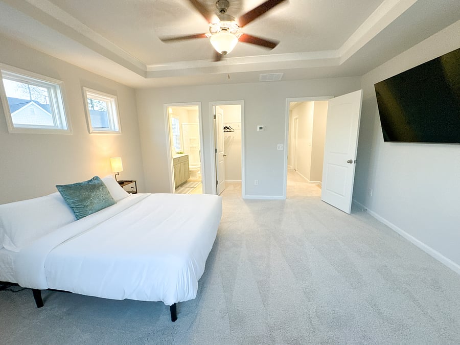 The primary bedroom features a cozy queen-size bed with soft linens and plenty of space to unwind.

