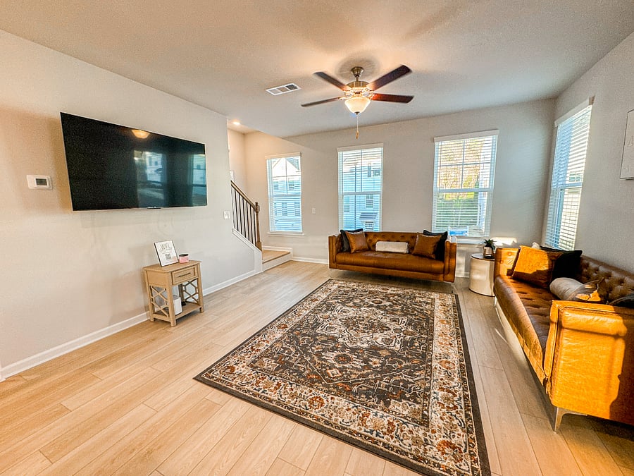 Bright and inviting living room with seamless flow to the kitchen and upstairs!
