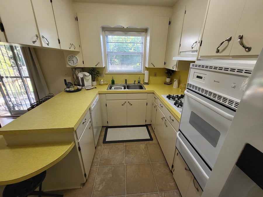 The kitchen features the conveniences of home: a dining area, coffee maker, microwave, full size range, cookware, and dining ware. 