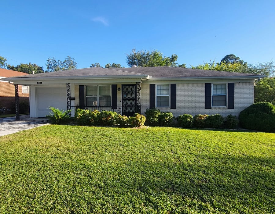 The flat lot includes a spacious 1-car garage, offering off-street parking. 