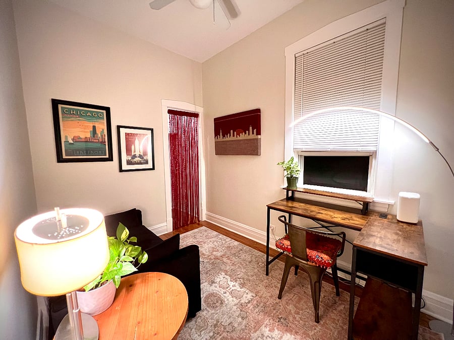 This is the view from the door to the 2nd bedroom, The Chicago Room. Here you can see the dedicated workspace which features a corner desk that has USB and USB-C ports as well as power outlets built into the desk for your convenience. In addition you can use the modern arch light by tapping the floor button.
The twin sofa bed pulls out into a sleeper sofa. There are additional bedding items in the close behind the fringe door to add to the sofa for a more plush experience. There is a pillow inside the closet as well
There is a motorized blow up air mattress in the closet.