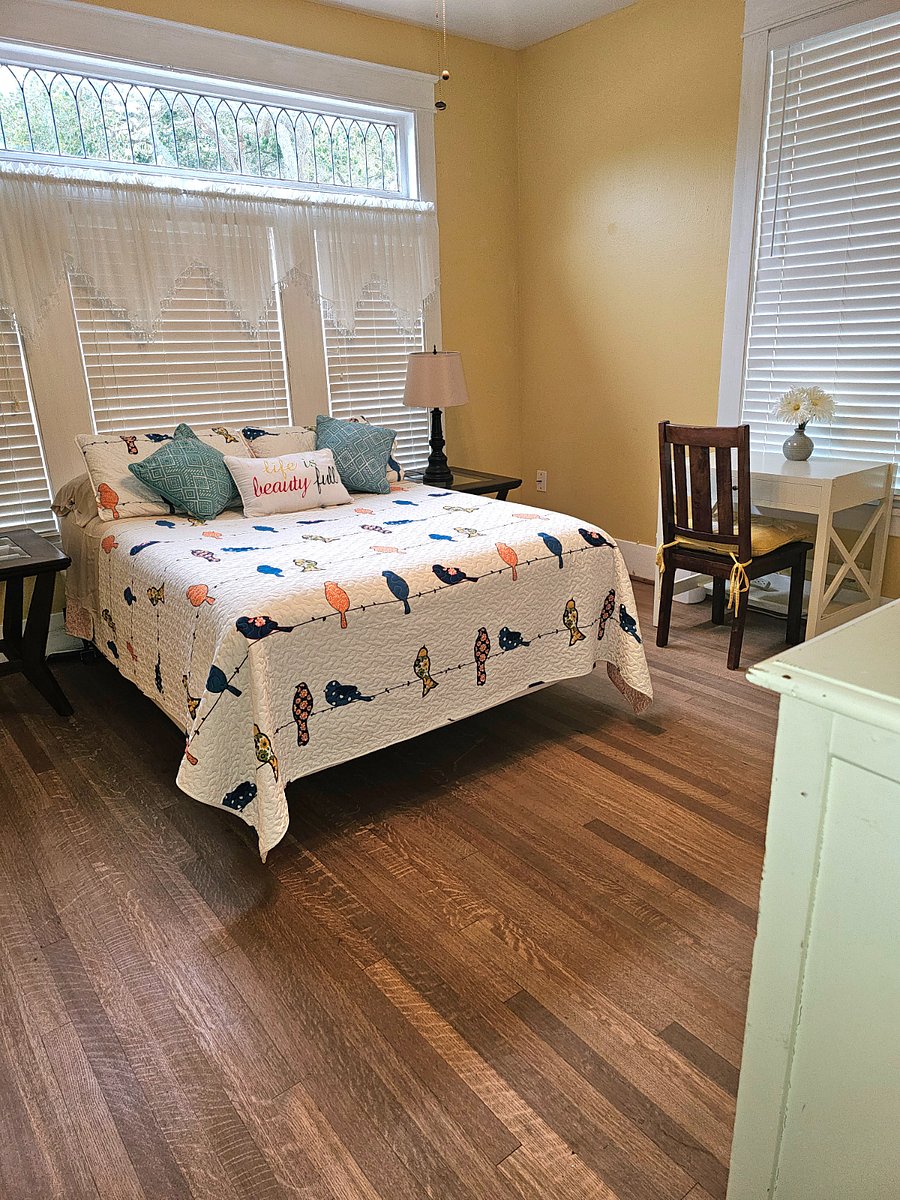 Full size bed with desk and chair.