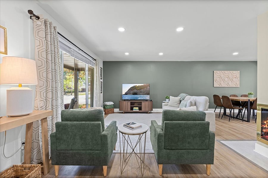 Natural light, overhead dimmer lights and side table lighting in the main living space.