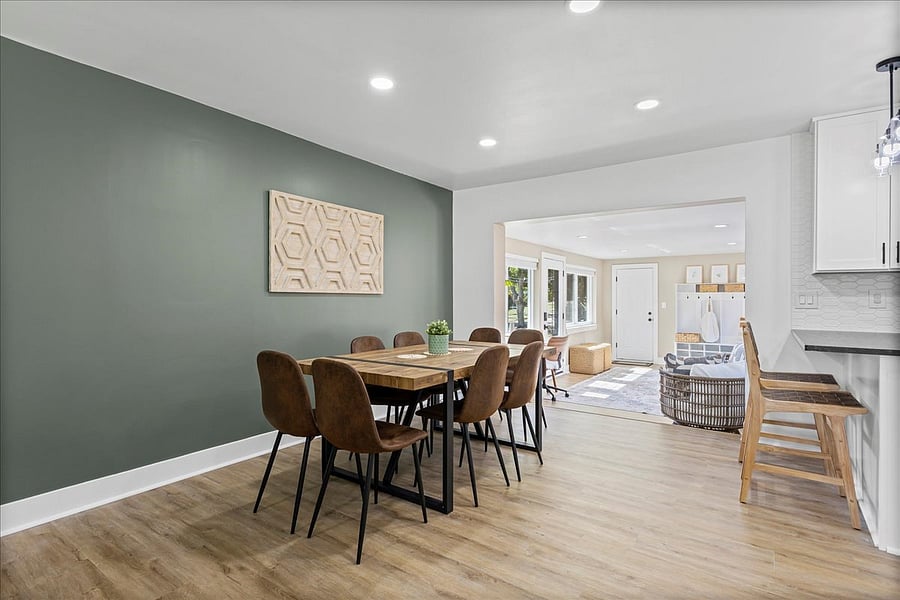 Dining Area opens to bright breezeway with side door entrance equipped with smart lock.