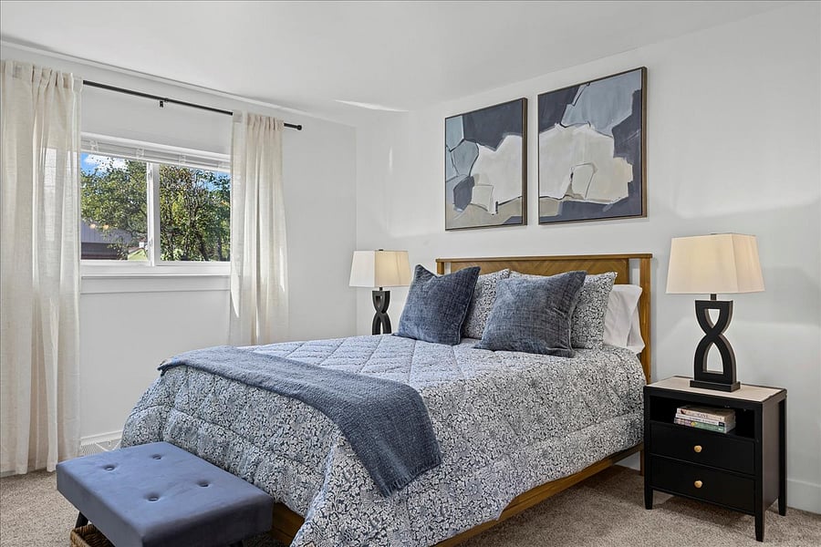 Spacious primary suite bedroom with queen bed and comfortable bedding is perfect to relax after a good day's work...or anytime!
