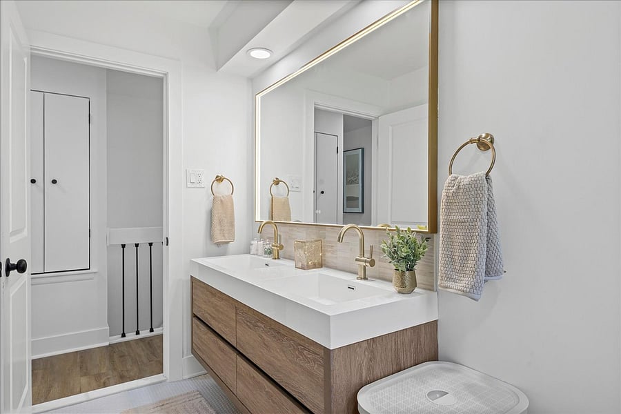 Double vanity and linen closet just in hall provide plenty of room for all the extras.