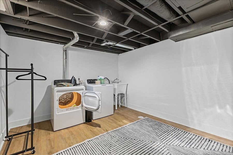 Laundry room with ironing board, hanging rack, laundry supplies to get started and lots of space if you need to store anything.
