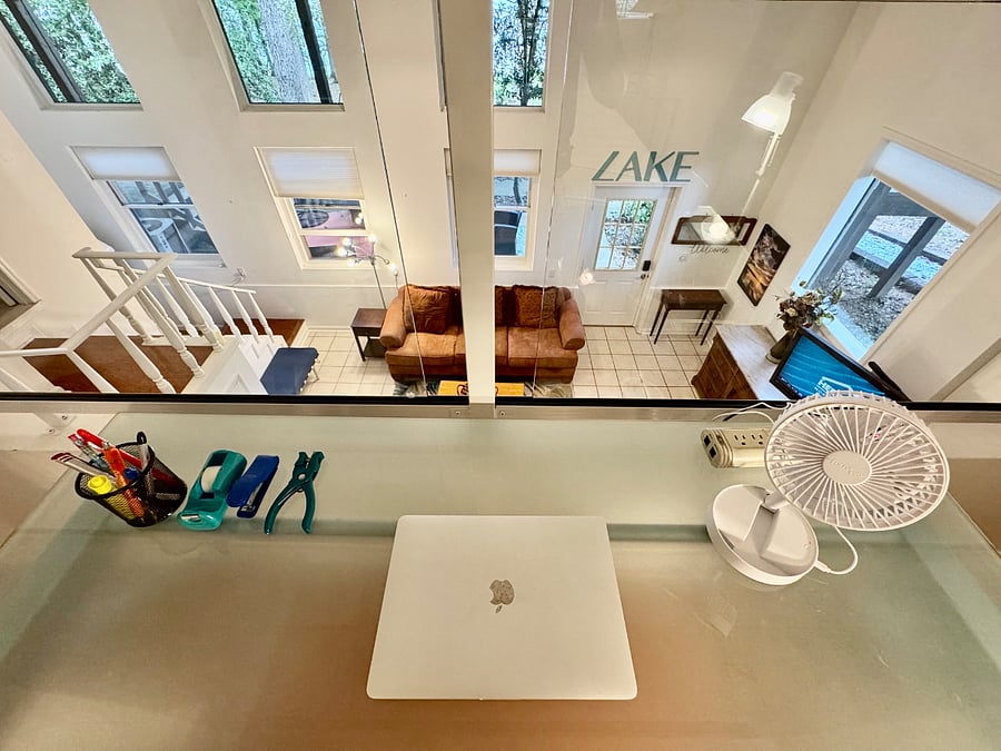 Work space overlooks living room with 7 windows. Enjoy the direct view of the lake as you tap away