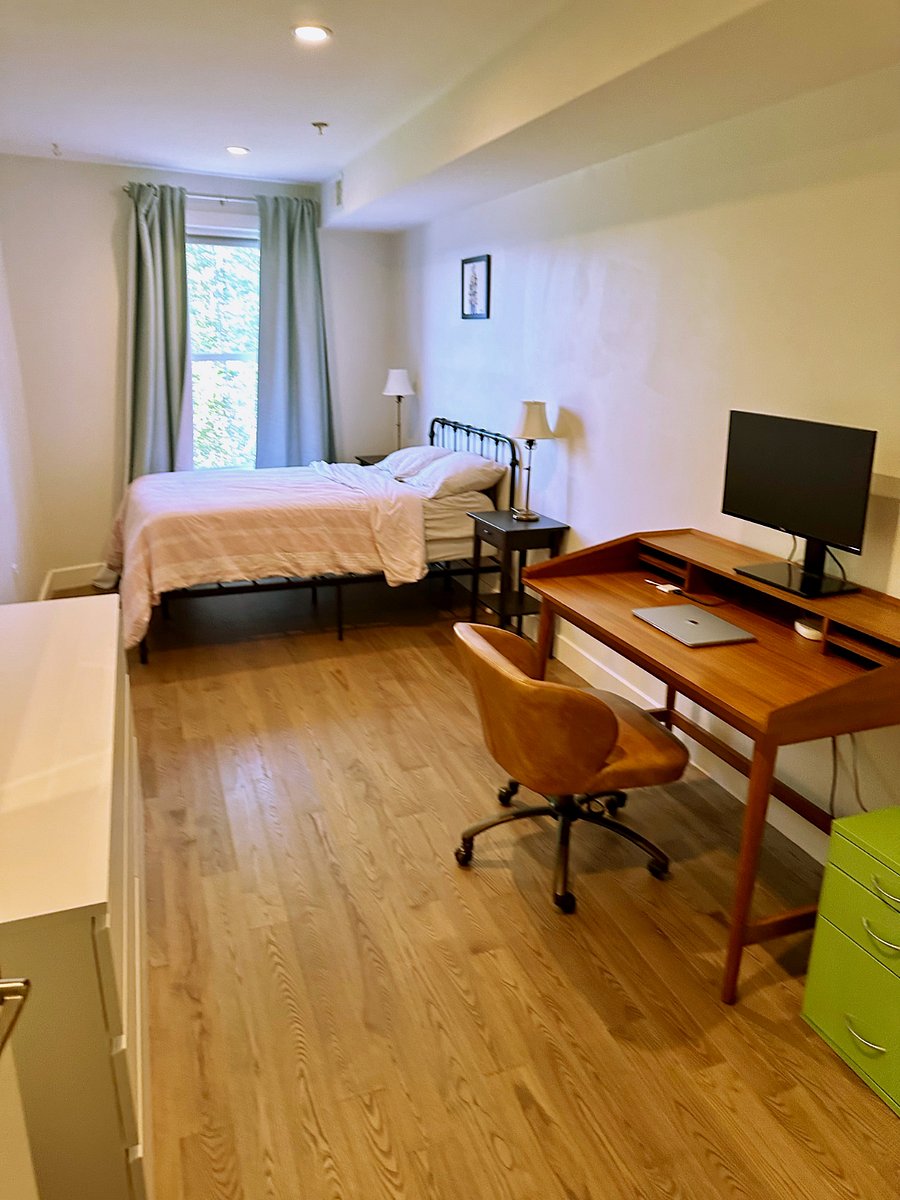 This is the second bedroom with a lovely desk + full sized bed with linen bedding and oversized down comforter.  There are two bathrooms in the apartment -- the bathroom for this bedroom is out in the hallway.