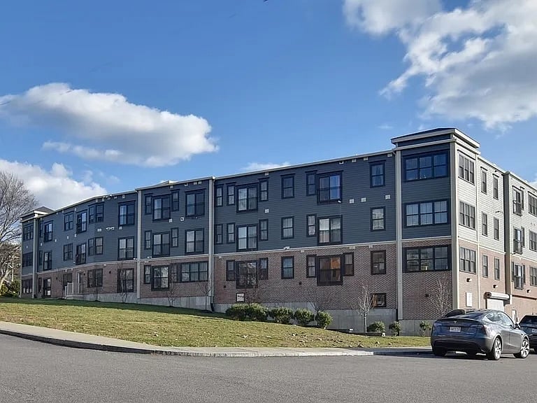 Exterior of the building.  The building has 3 residential floors + a garage level.  There is an elevator.  This unit is on the first residential level (so, the second floor of the building).  The building is situated on a hill, so you enter on level 2 from the street.