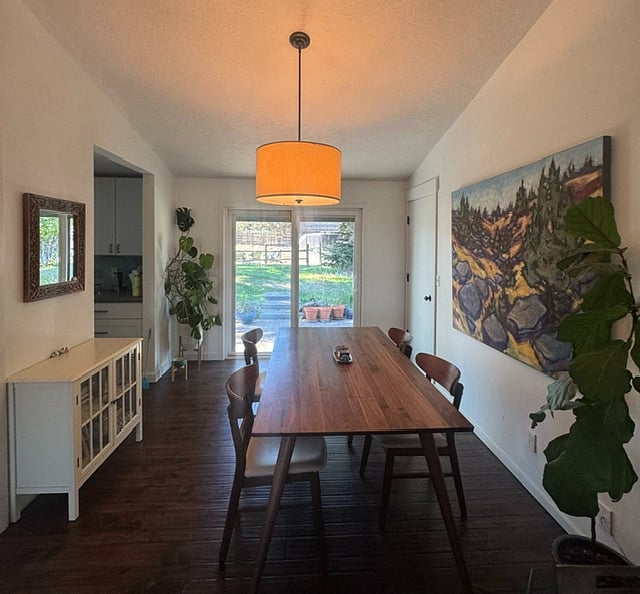 Modern dining room adjoins the kitchen, sliding glass doors to back patio and yard, BBQ and smoker. Opens onto living room.