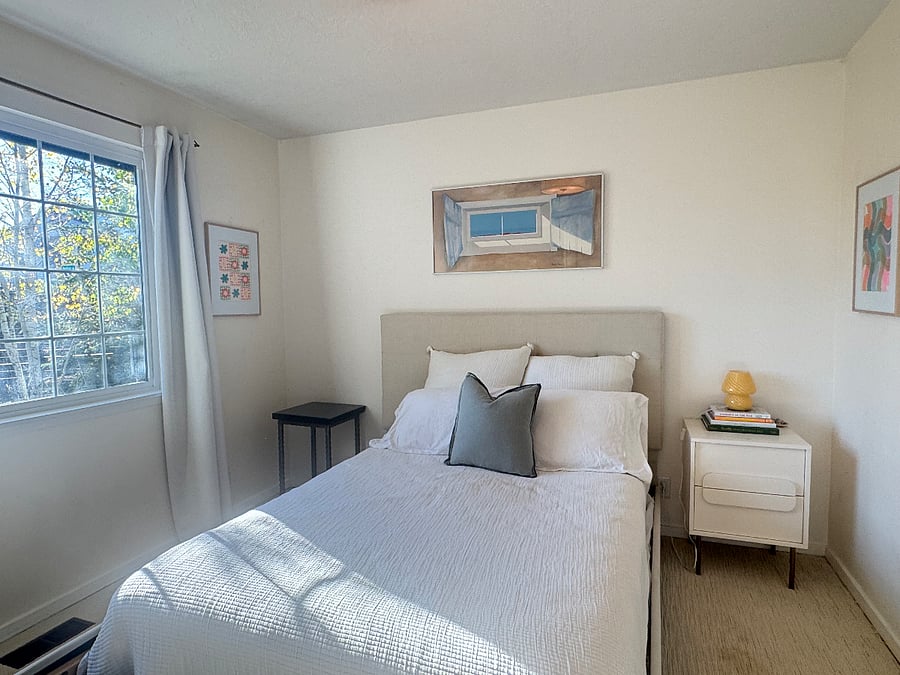 2nd bedroom, queen bed, beautiful morning light. Full closet, dresser and bookshelf.