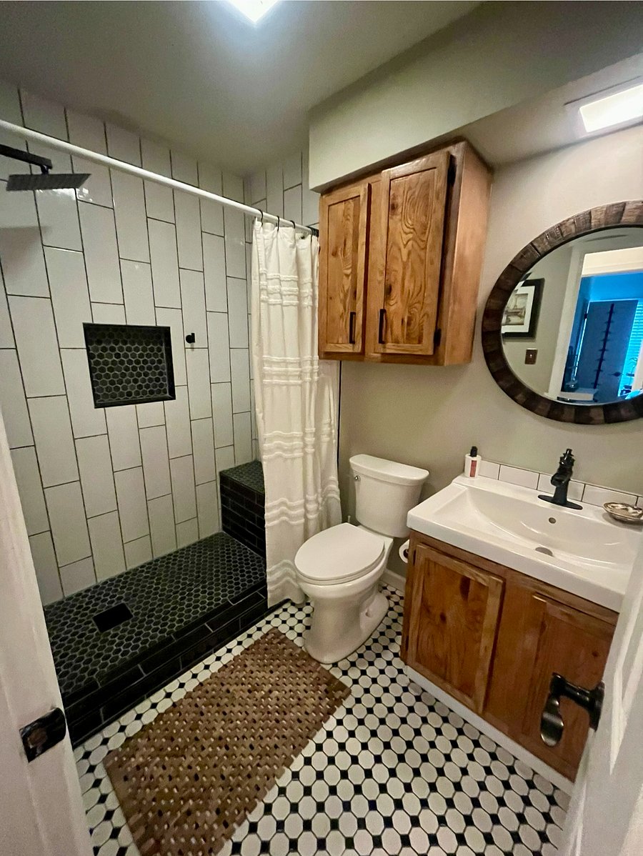 Guest bathroom off of hallway. Recently renovated shower with bench and second removable shower head.