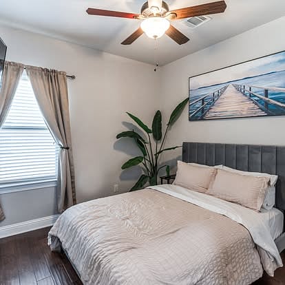 Guest room with queen bed, tv and walk-in closet