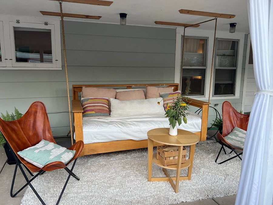 Porch bed is lovely place to relax on the covered front porch. 
