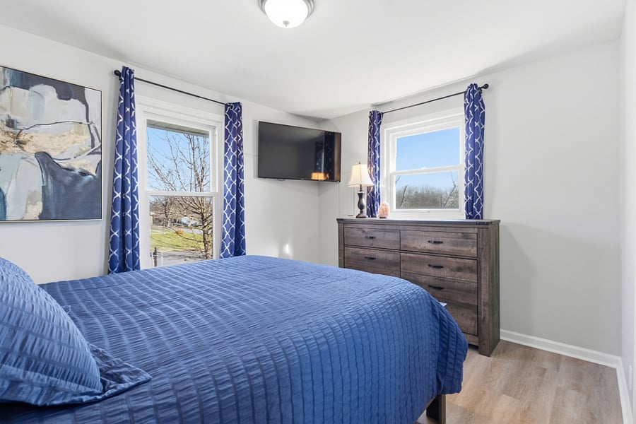 Front "blue" bedroom features largest closet, roll away bed storage, Smart TV, and North and East facing windows.