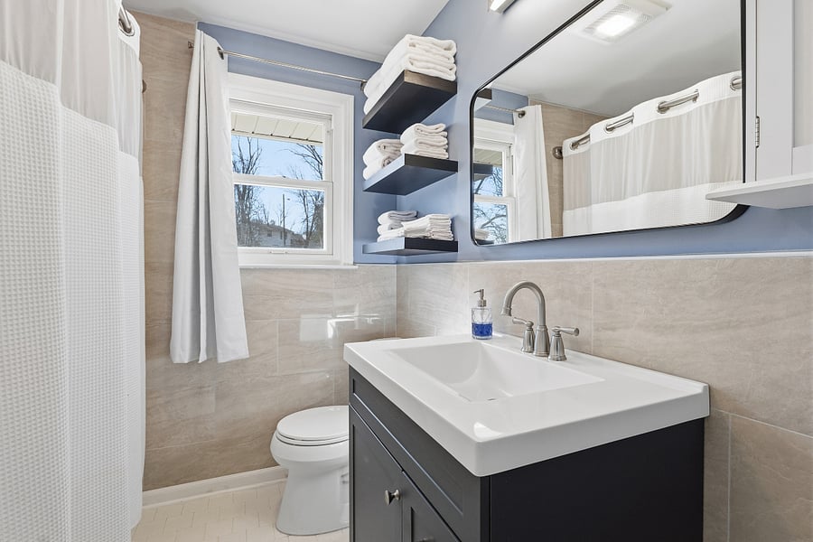 Renovated bathroom features bathtub/shower, 6 large towels, 12 hand towels, 12 wash clothes, hair dryer, first aid kit, and cleaning supplies.
