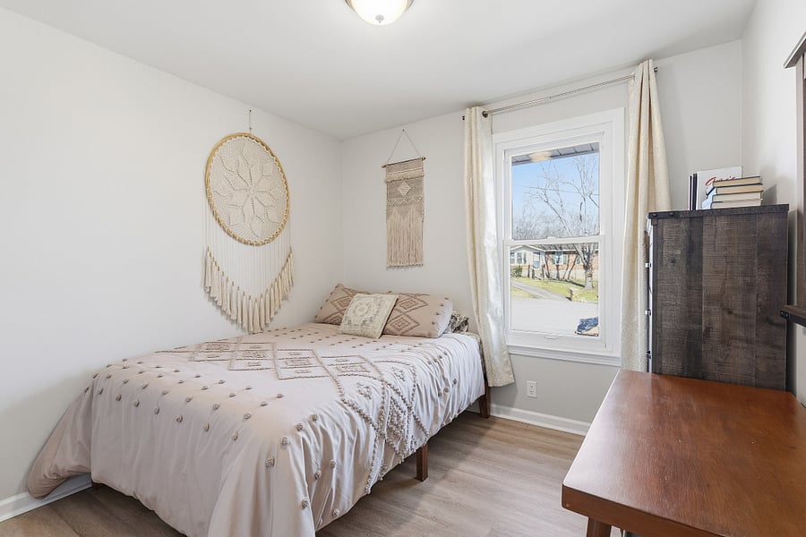 Front office bedroom features a desk, a Roku smart TV, and 1 north facing window.