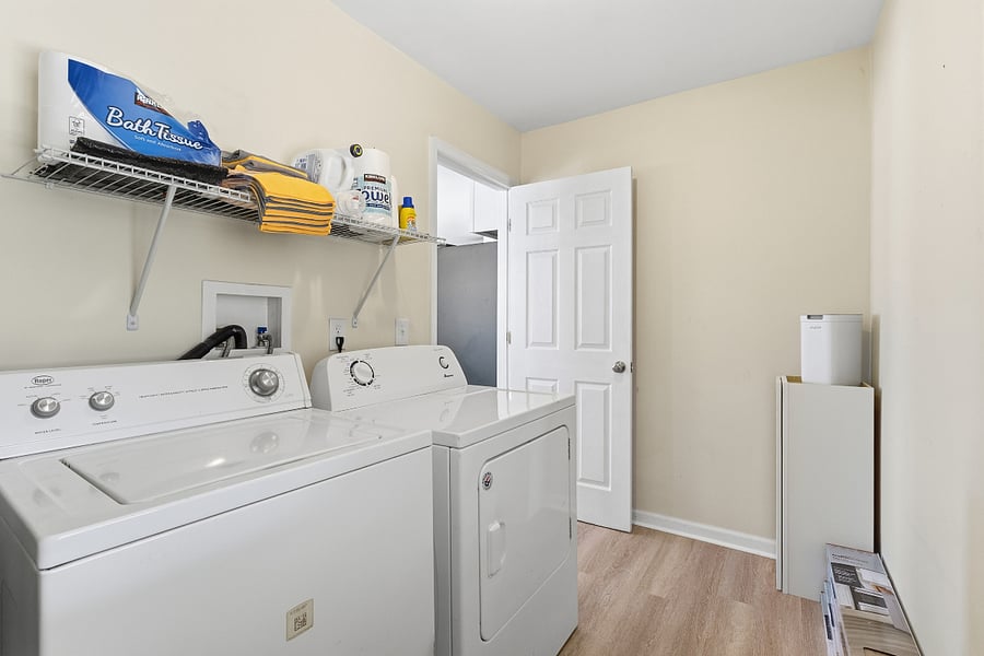Utilities room has water heater, full size washer and dryer, cleaning supplies, and some extra expendables. Back door leads to carport/ back yard.